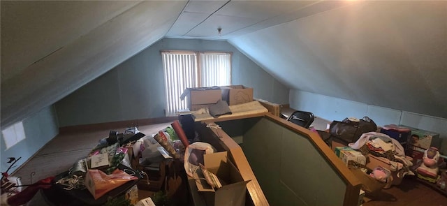bonus room with vaulted ceiling and carpet