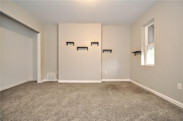 empty room with carpet and baseboards