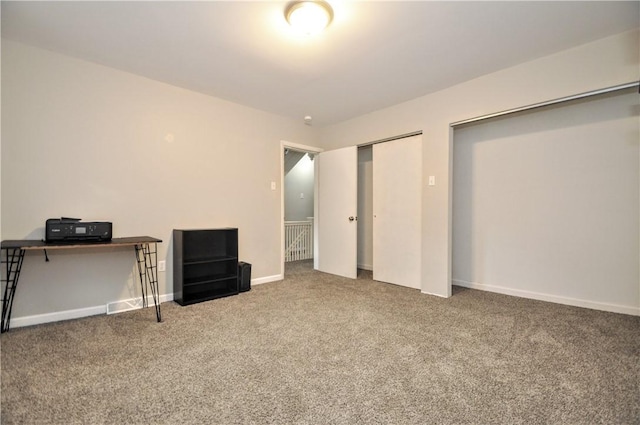 unfurnished bedroom with carpet flooring, baseboards, and a closet