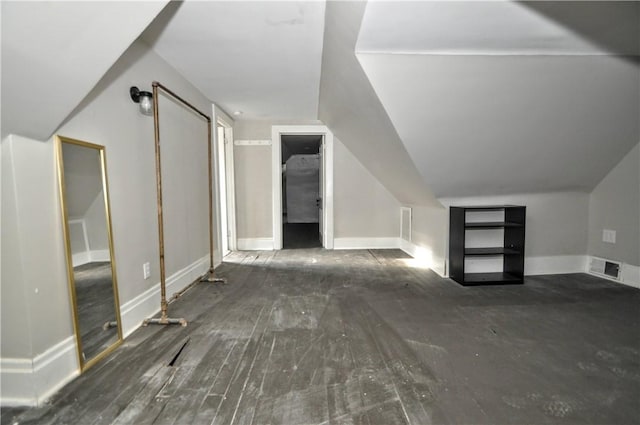 bonus room with baseboards and lofted ceiling