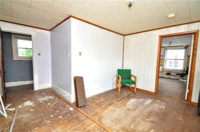 unfurnished room with baseboards and crown molding