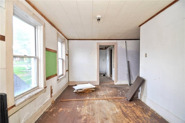 spare room featuring fire sprinkler in ceiling and hardwood / wood-style flooring