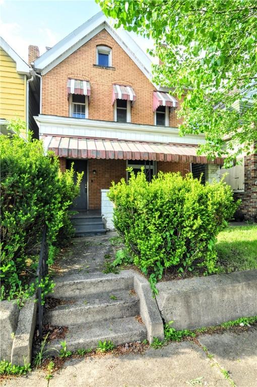 view of front of house featuring brick siding