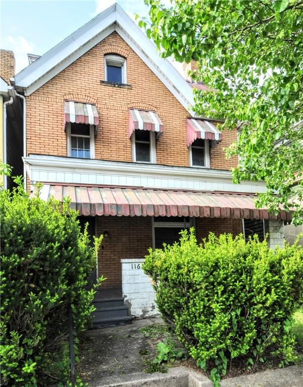 rear view of property featuring brick siding