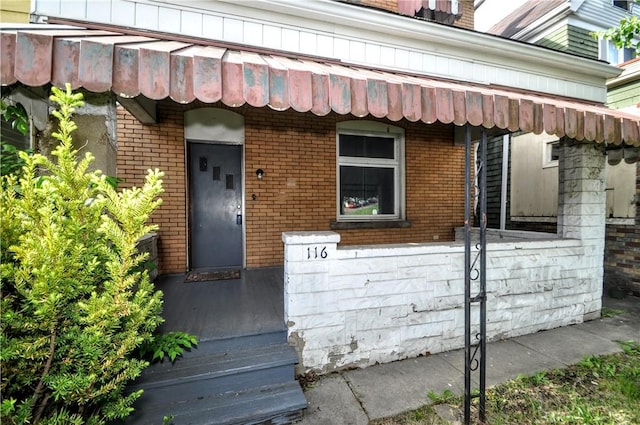 property entrance featuring brick siding
