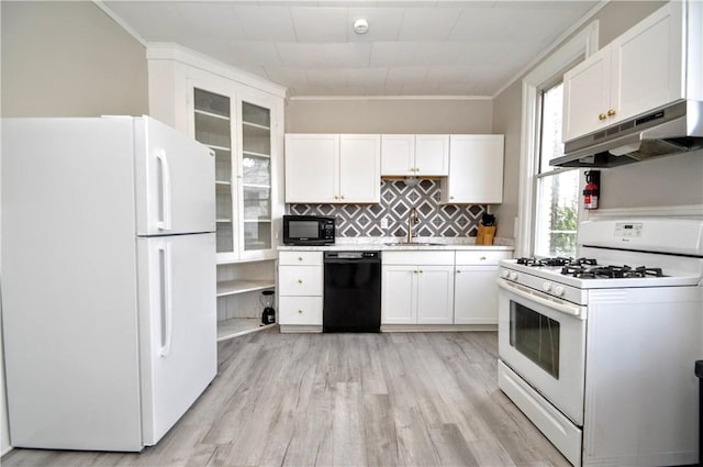 kitchen featuring black appliances, under cabinet range hood, a sink, white cabinets, and ornamental molding