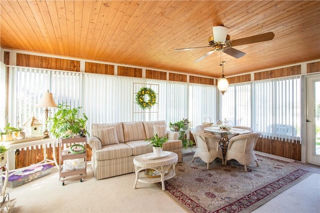sunroom / solarium featuring wood ceiling, carpet, and plenty of natural light
