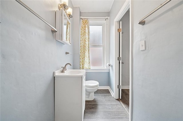 3474 Ligonier St, Lawrenceville, PA 15201 - full bath featuring wood finished floors, toilet, vanity, and baseboards
