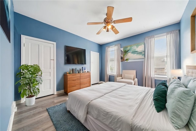 3474 Ligonier St, Lawrenceville, PA 15201 - bedroom featuring multiple windows, light wood-style floors, ceiling fan, and baseboards