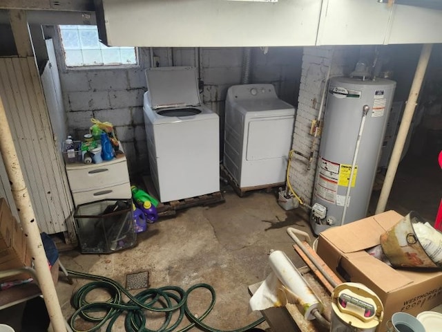 below grade area with water heater, independent washer and dryer, and concrete block wall