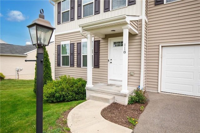 118 Leslie Farms Dr, Connoquenessing Boro, PA 16033 - view of exterior entry with an attached garage and a lawn