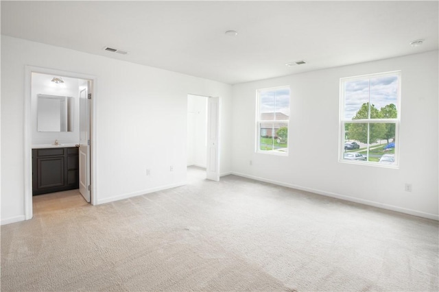 118 Leslie Farms Dr, Connoquenessing Boro, PA 16033 - unfurnished bedroom featuring light carpet, baseboards, a spacious closet, and a sink