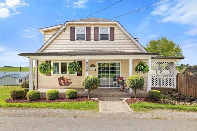 317 E Ross St, Worthington, PA 16262 - view of front facade with covered porch, fence, and roof with shingles