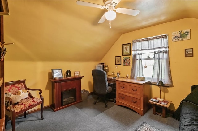office featuring lofted ceiling, carpet, ceiling fan, and a fireplace