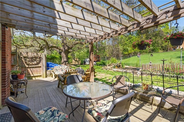 wooden deck with a pergola and outdoor dining area