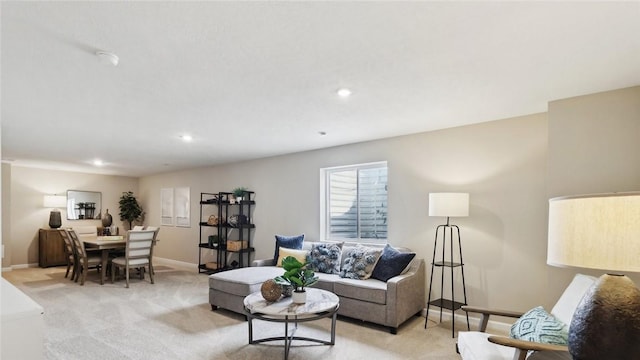 living area featuring light carpet, baseboards, and recessed lighting
