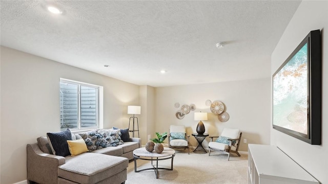 living area with healthy amount of natural light, a textured ceiling, light carpet, recessed lighting, and baseboards
