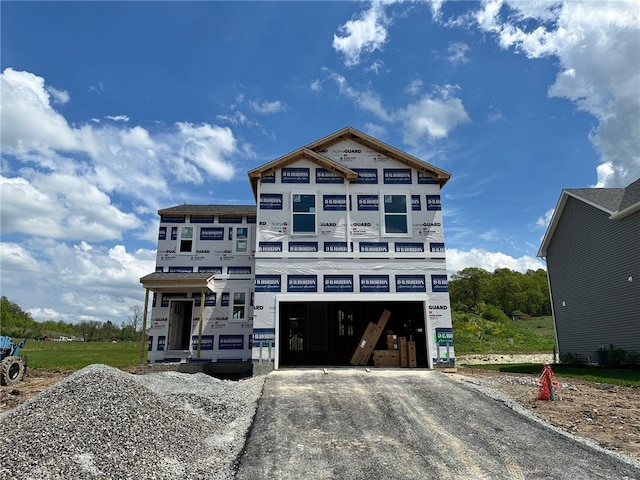 property in mid-construction with driveway and an attached garage