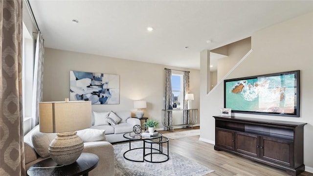 living room featuring light wood-style flooring and baseboards