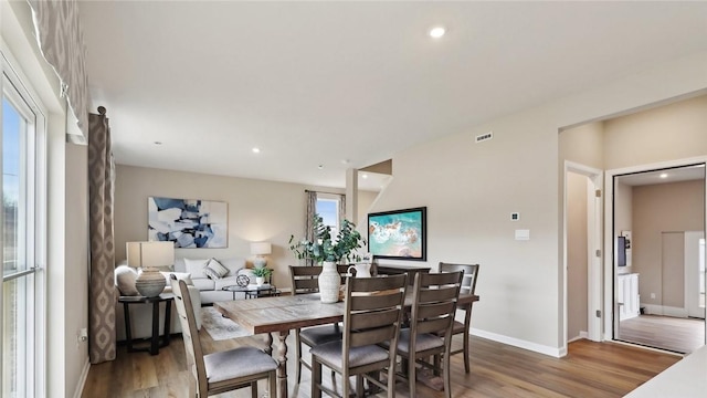 dining area with wood finished floors, baseboards, and recessed lighting