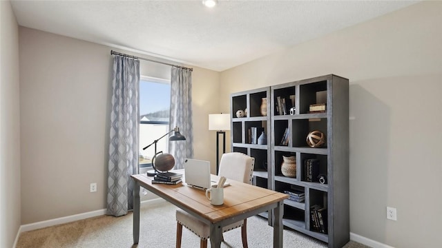 carpeted home office featuring baseboards