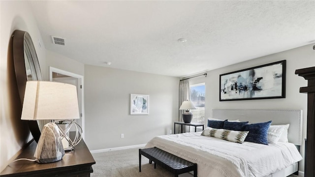 bedroom featuring carpet, baseboards, and a textured ceiling