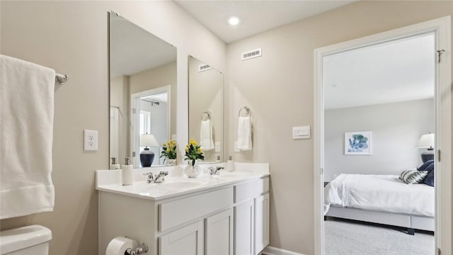 ensuite bathroom with toilet and double vanity