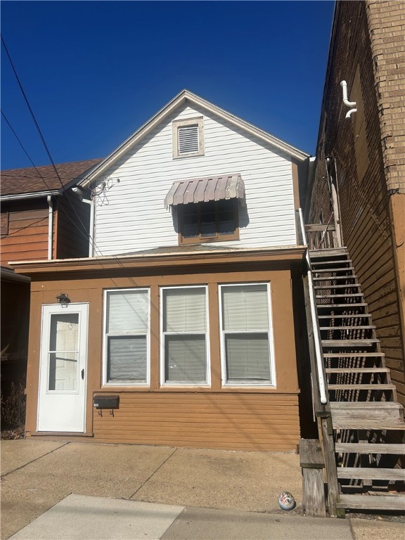 rear view of house featuring stairs