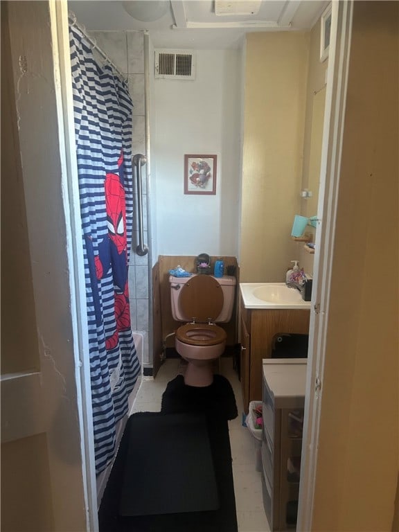 bathroom featuring a stall shower, vanity, and toilet