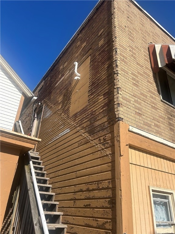 view of side of home featuring stairs