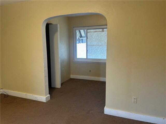 704/706 Holland St, Vandergrift Wml, PA 15690 - carpeted empty room with arched walkways and baseboards