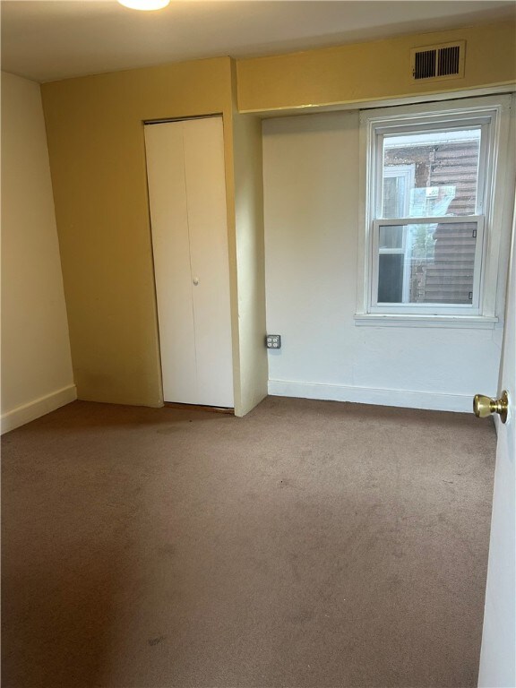 704/706 Holland St, Vandergrift Wml, PA 15690 - unfurnished bedroom with carpet, a closet, and baseboards