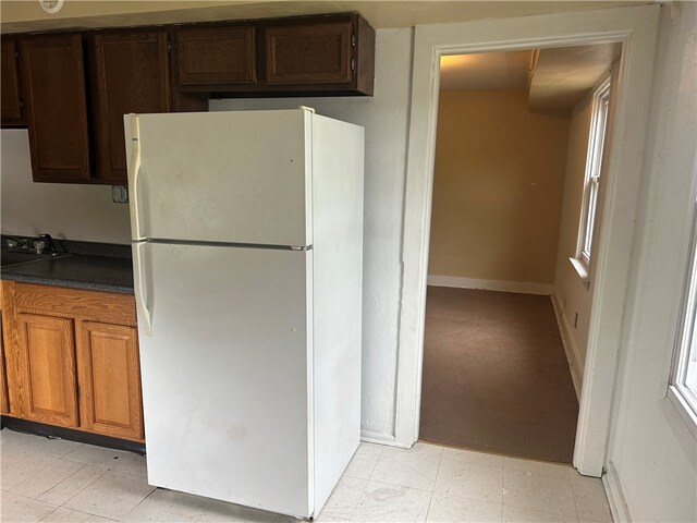 704/706 Holland St, Vandergrift Wml, PA 15690 - kitchen with freestanding refrigerator, dark countertops, light floors, and baseboards