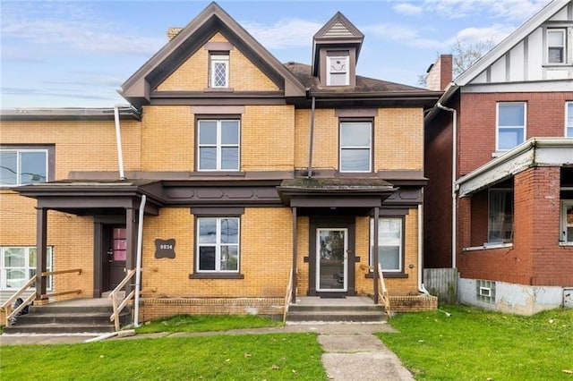 3014 Versailles Ave, Mckeesport, PA 15132 - view of front of home with brick siding, a front lawn, and a chimney