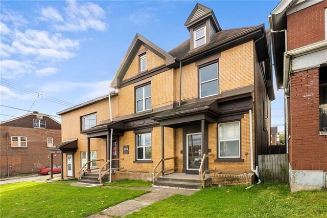 3014 Versailles Ave, Mckeesport, PA 15132 - townhome / multi-family property featuring brick siding and a front lawn