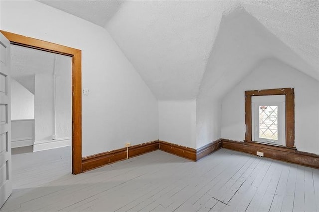 3014 Versailles Ave, Mckeesport, PA 15132 - bonus room featuring lofted ceiling, wood finished floors, a textured ceiling, and baseboards