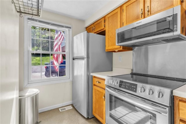 1408 Timberidge Dr, Bethel Park, PA 15102 - kitchen featuring appliances with stainless steel finishes, light countertops, baseboards, and brown cabinets