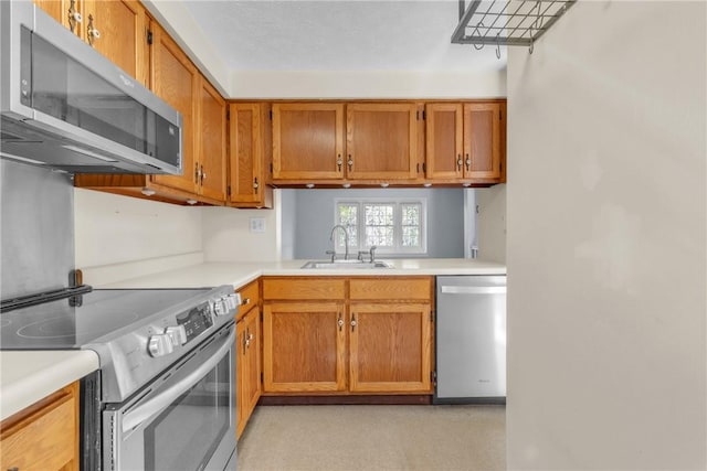 1408 Timberidge Dr, Bethel Park, PA 15102 - kitchen with stainless steel appliances, a sink, light countertops, and brown cabinets