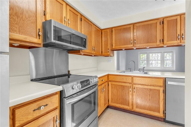 1408 Timberidge Dr, Bethel Park, PA 15102 - kitchen featuring stainless steel appliances, a sink, light countertops, and brown cabinets