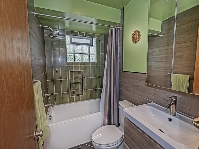 full bathroom featuring shower / bath combo with shower curtain, toilet, wood walls, and vanity