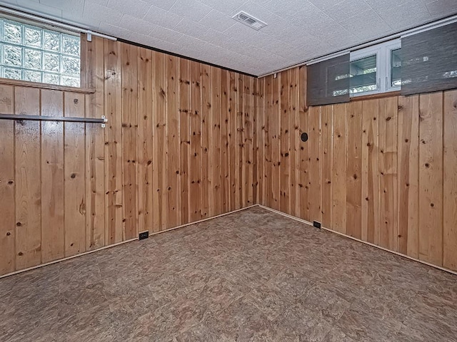 spare room featuring wooden walls