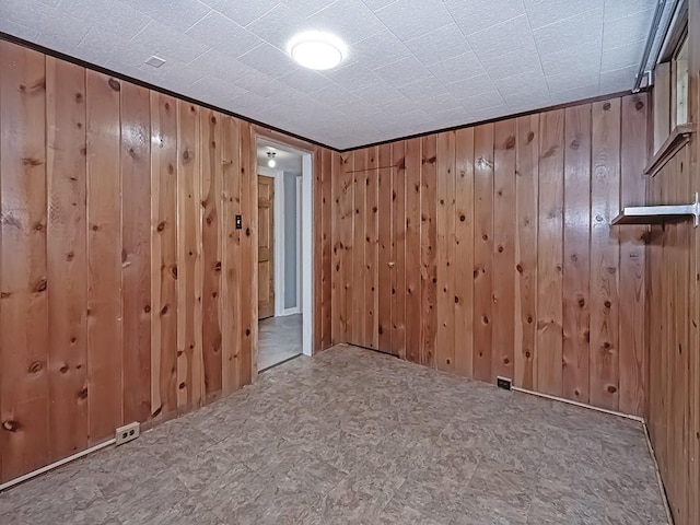 spare room featuring wood walls and tile patterned floors