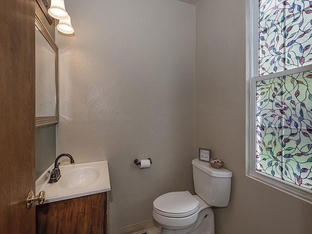 bathroom featuring toilet and vanity