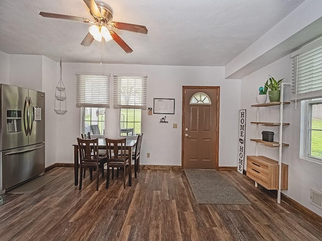 entryway featuring dark wood-type flooring, a ceiling fan, healthy amount of natural light, and baseboards