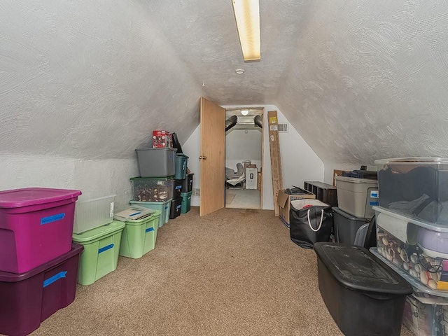bonus room with a textured ceiling, carpet flooring, and vaulted ceiling