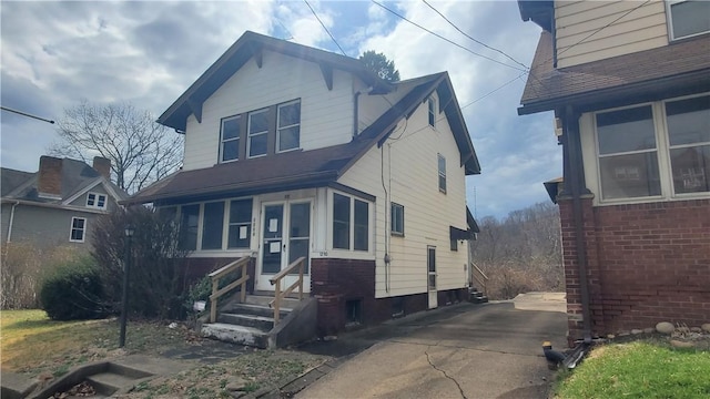 1710 3rd Ave, New Brighton, PA 15066 - view of front facade featuring entry steps, a shingled roof, and driveway