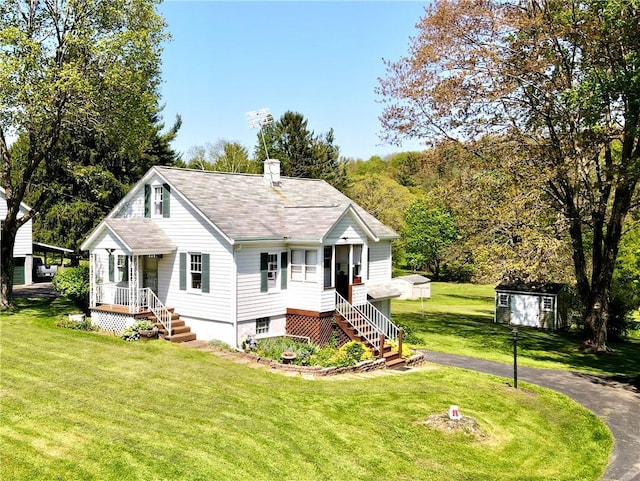 825 Saxonburg Rd, Jefferson Twp But, PA 16002 - view of front of house featuring an outdoor structure, a front yard, a storage shed, a chimney, and roof with shingles