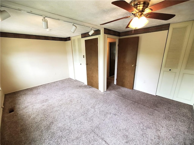 620 Gross St, Conway, PA 15027 - unfurnished bedroom with carpet floors, rail lighting, and a ceiling fan
