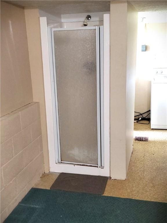 620 Gross St, Conway, PA 15027 - bathroom featuring washer / clothes dryer, a stall shower, and tile patterned floors
