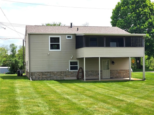 620 Gross St, Conway, PA 15027 - back of property featuring a yard, stone siding, a sunroom, and a patio area